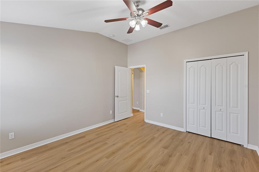 506 Rainbow Springs Loop Groveland, FL 34736 - Photo 16 of 30 a view of an empty room with wooden floor