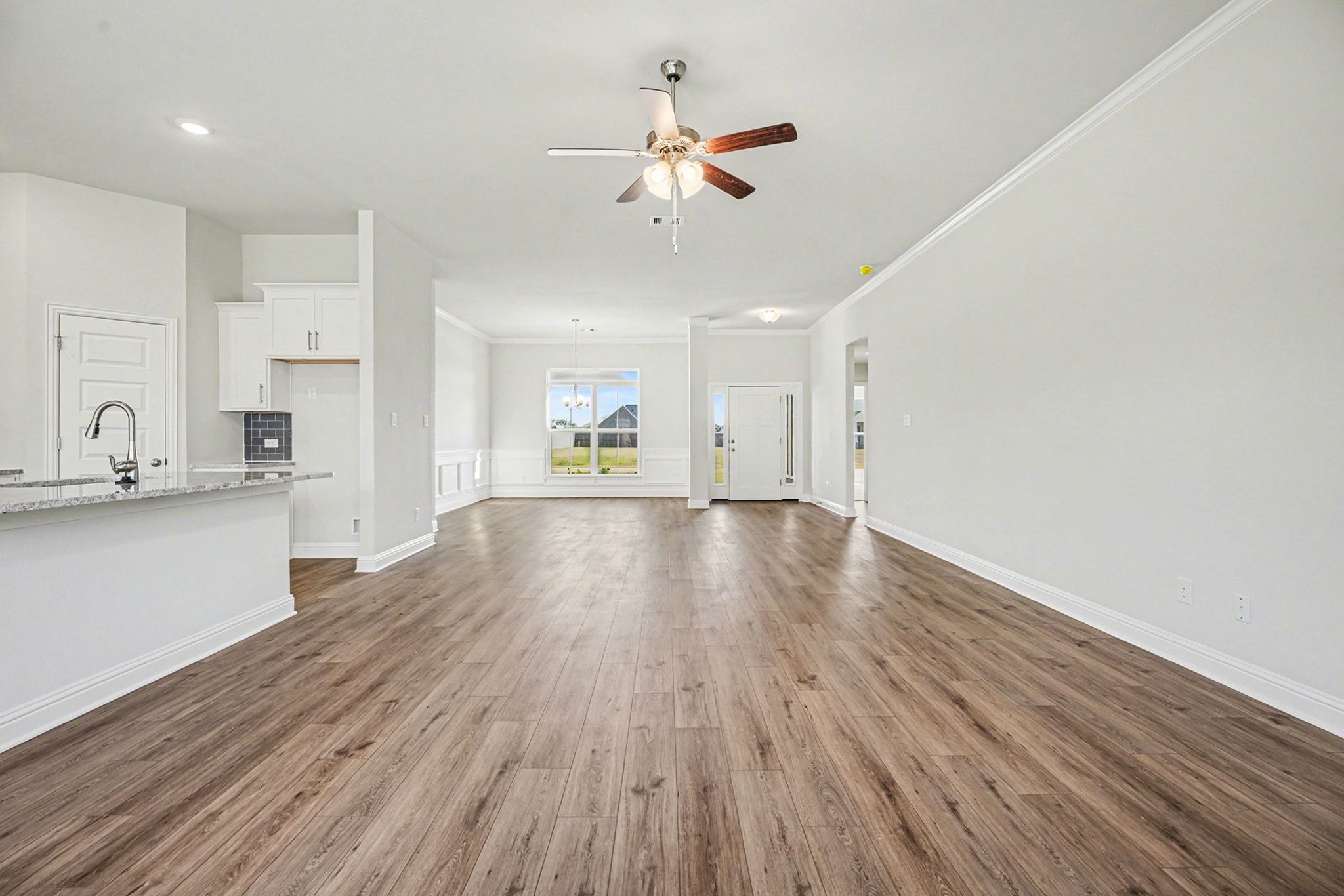 5 Keystone Court Angleton, TX 77515 - Photo 7 of 33 a view of an empty room and kitchen view with wooden floor