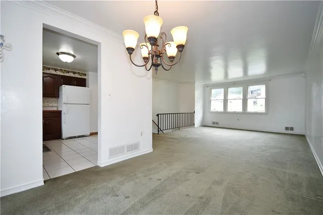 a view of a hallway with a chandelier