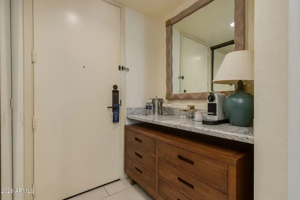 a bedroom with a bed and a lamp on table