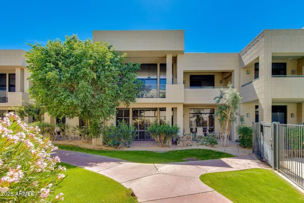 a bedroom with two beds and large windows