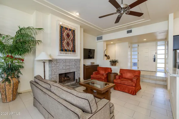 a view of an empty room with stairs and a window