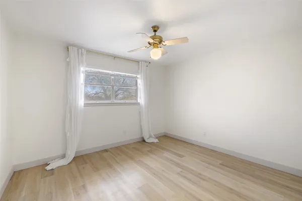 a bedroom with a bed and a large mirror