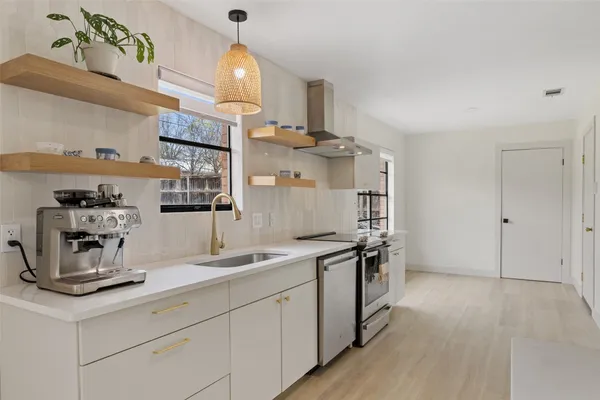 a view of a livingroom with a fireplace wooden floor and window