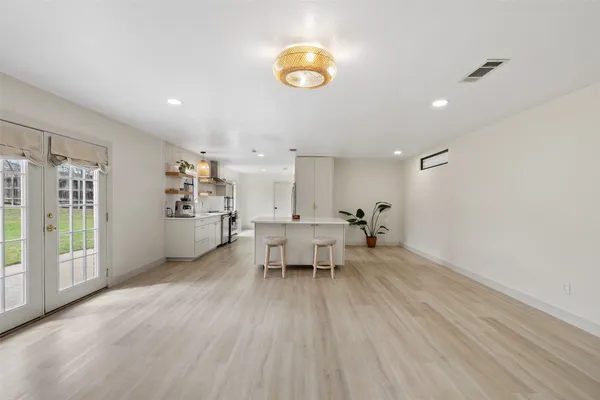a large kitchen with a large counter top appliances and cabinets