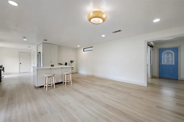a kitchen with granite countertop a sink and refrigerator