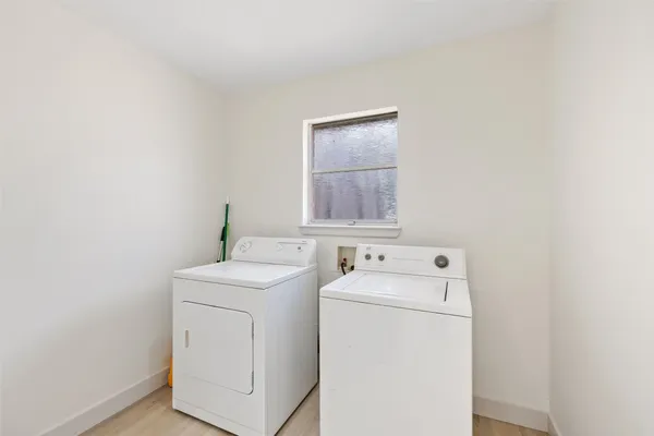 a view of a room with a window and wooden floor