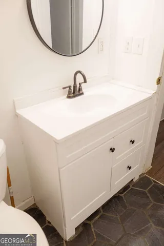 a bathroom with a sink and a mirror