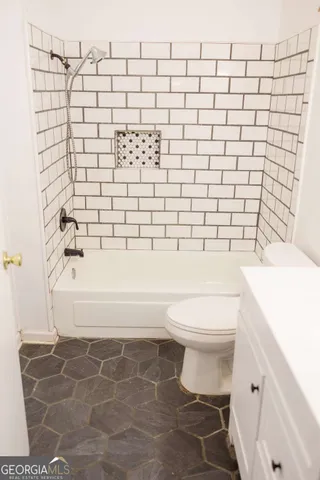 a bathroom with a toilet and a bathtub