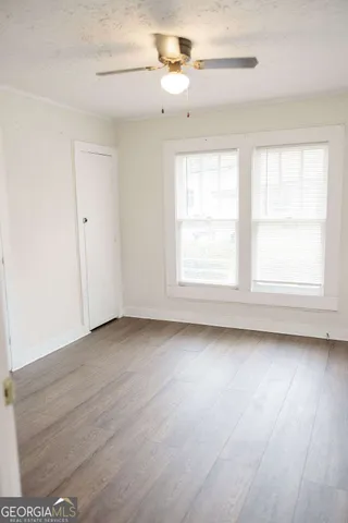 wooden floor in an empty room with a window