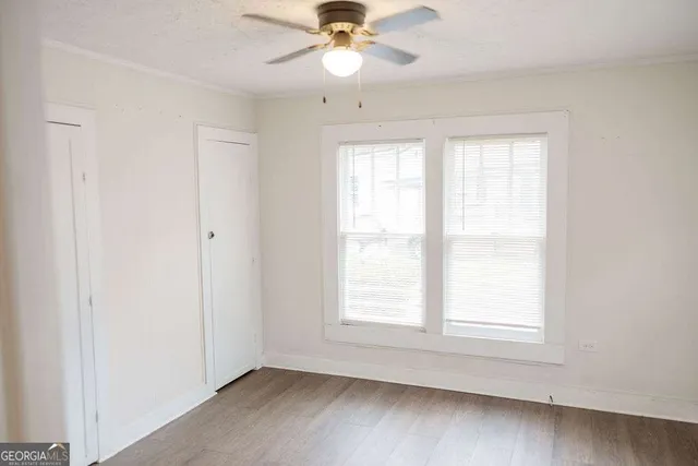 wooden floor in an empty room with a window