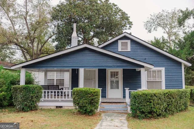 a front view of a house with garden