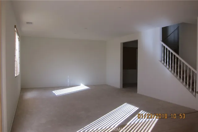 a view of an empty room with stairs