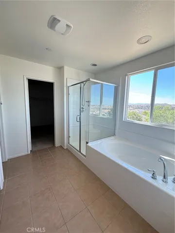a spacious bathroom with a bathtub and a shower