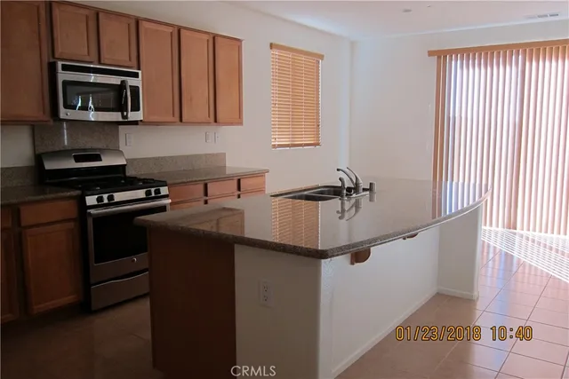 a kitchen with a sink and stainless steel appliances