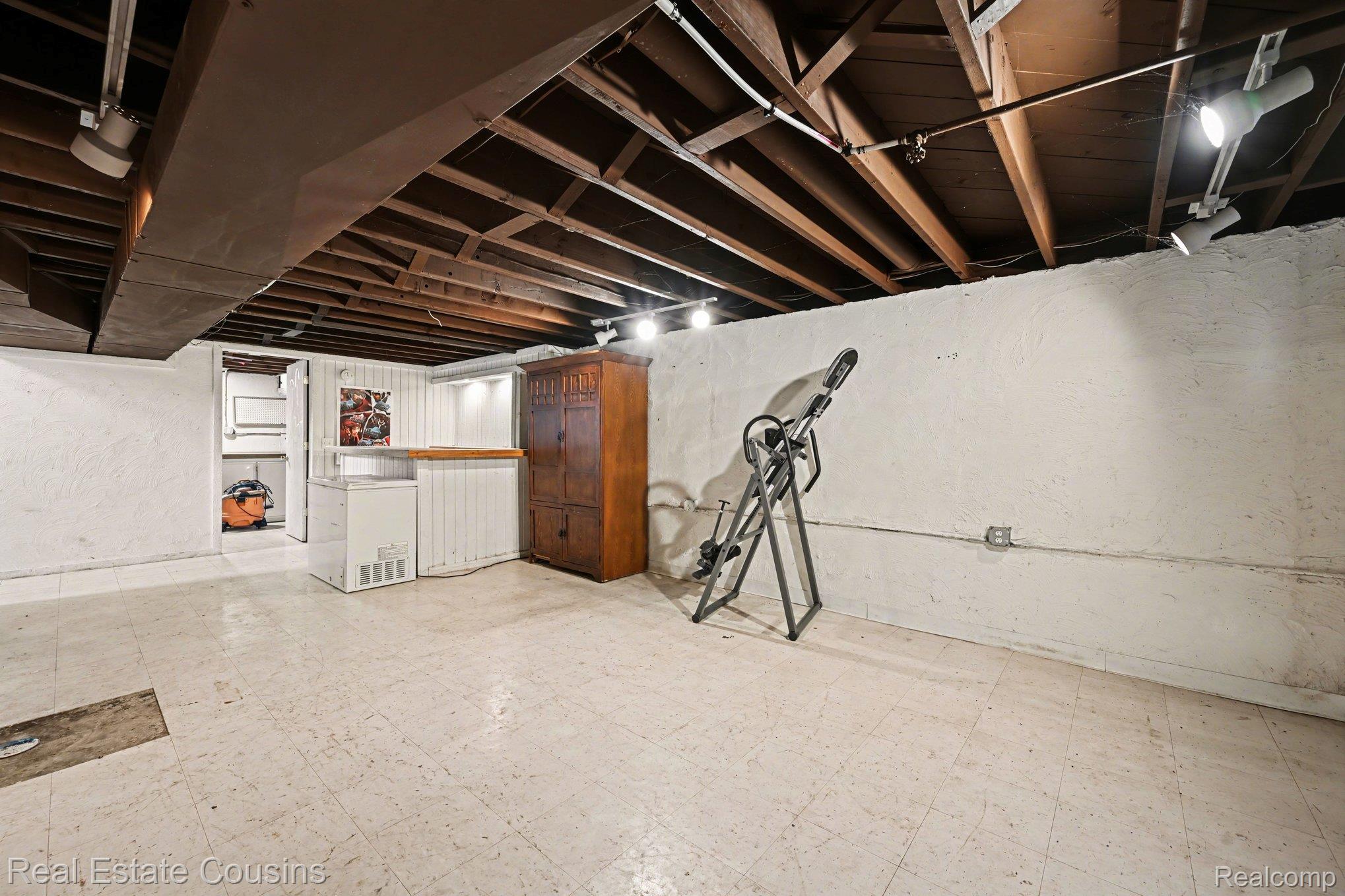32224 Joy Road Livonia, MI 48150 - Photo 19 of 33 Unfinished below grade area featuring light flooring, white refrigerator, and a textured wall