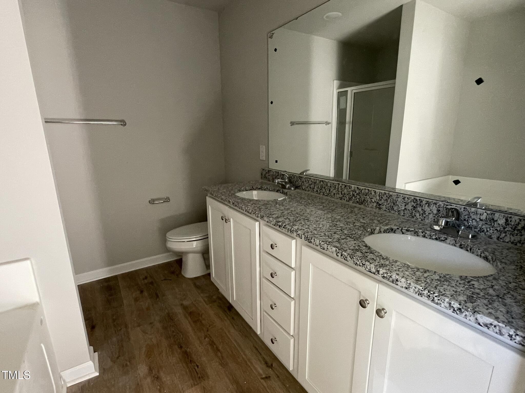 42 Heatherglenn Circle Princeton, NC 27569 - Photo 11 of 15 a bathroom with a granite countertop sink a toilet and a mirror