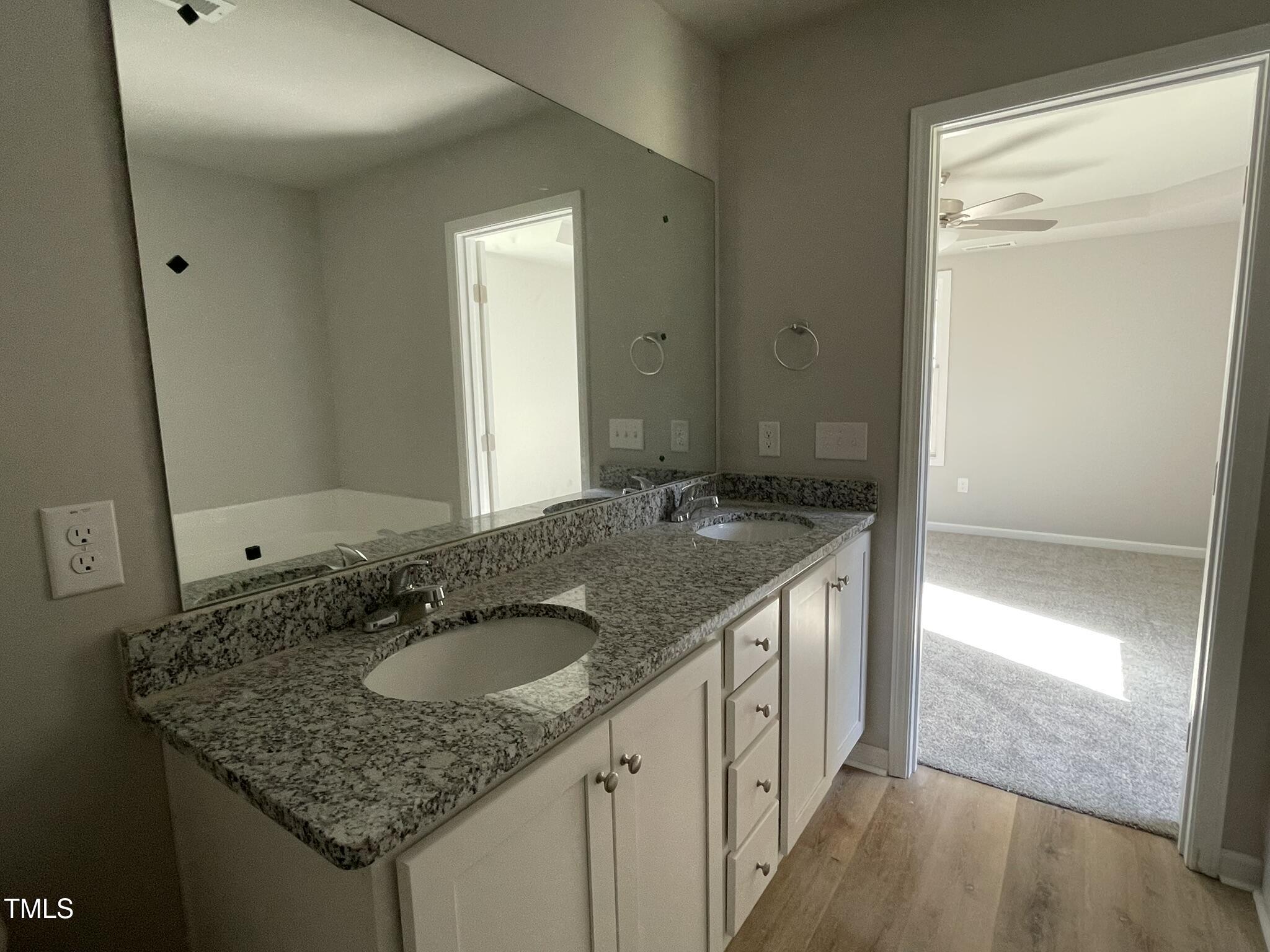 42 Heatherglenn Circle Princeton, NC 27569 - Photo 10 of 15 a bathroom with a granite countertop sink and a mirror