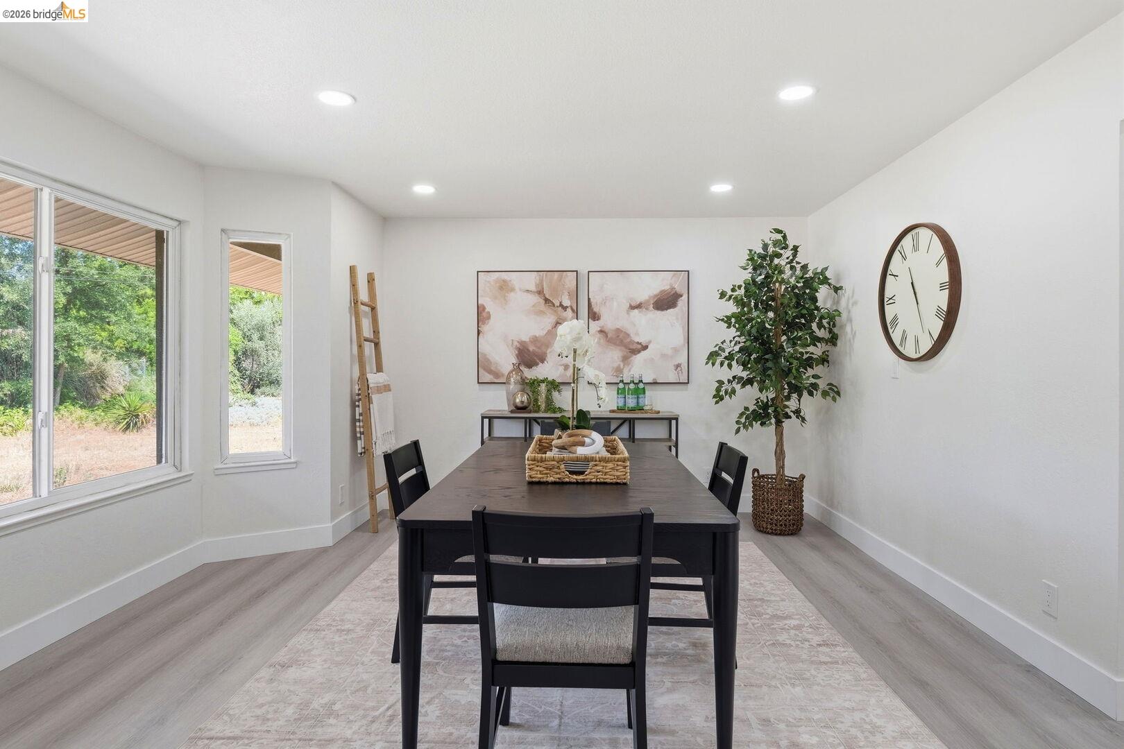 1590 Sunset Road Brentwood, CA 94513 - Photo 15 of 45 Dining area featuring bay windows, light wood-finish flooring, recessed lighting, and crisp white walls