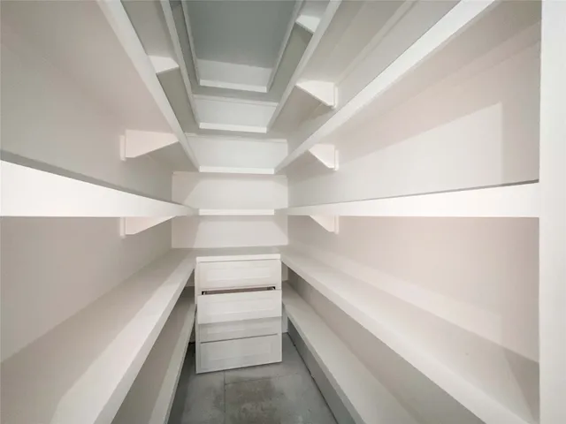 a view of a hallway with stairs and a white walls