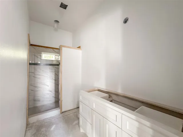 an empty room with windows and closet