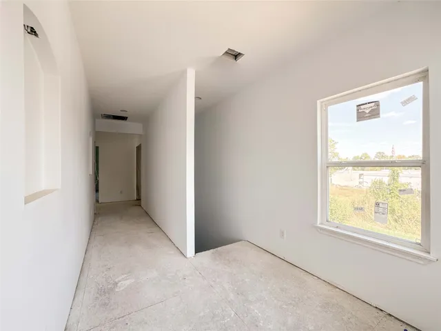 an empty room with windows and closet