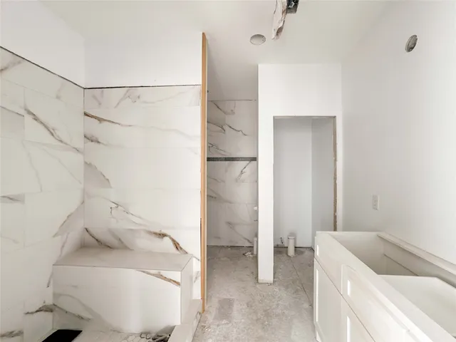 a bathroom with a shower and a glass door