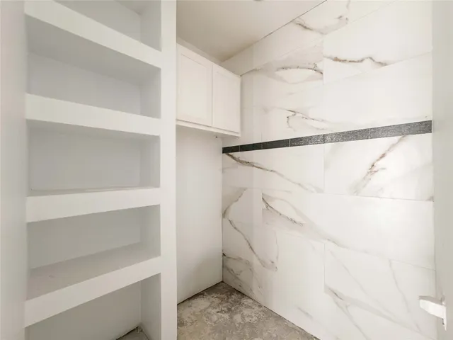 a bathroom with a double vanity and a tub