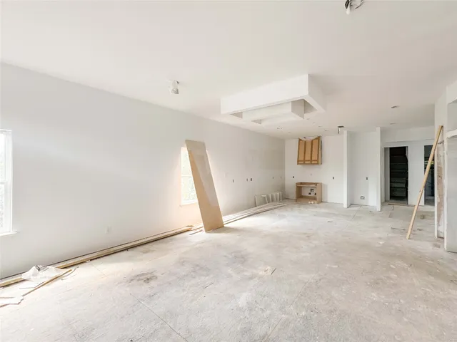 a view of a big room with closet and windows