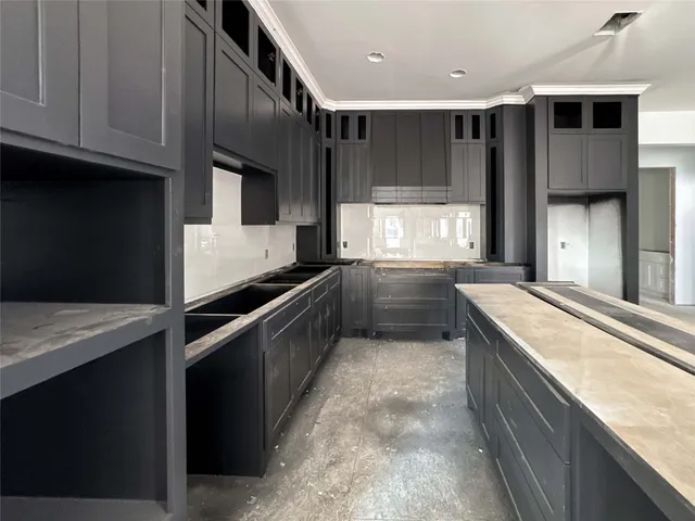 a kitchen with kitchen island cabinets and oven