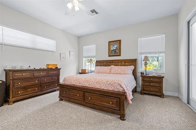 a bathroom with a granite countertop sink a toilet a mirror and shower