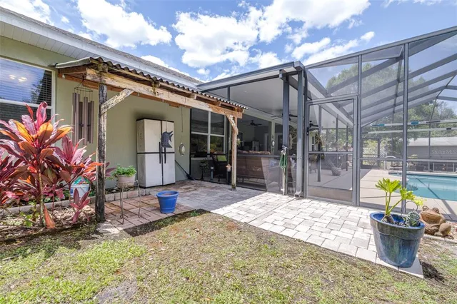 an aerial view of residential houses with outdoor space and trees