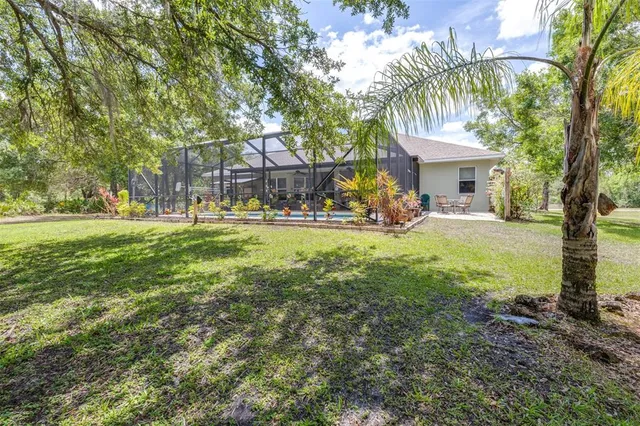 an aerial view of a house with yard swimming pool and outdoor seating