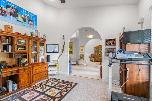 a living room with furniture a chandelier and a dining table
