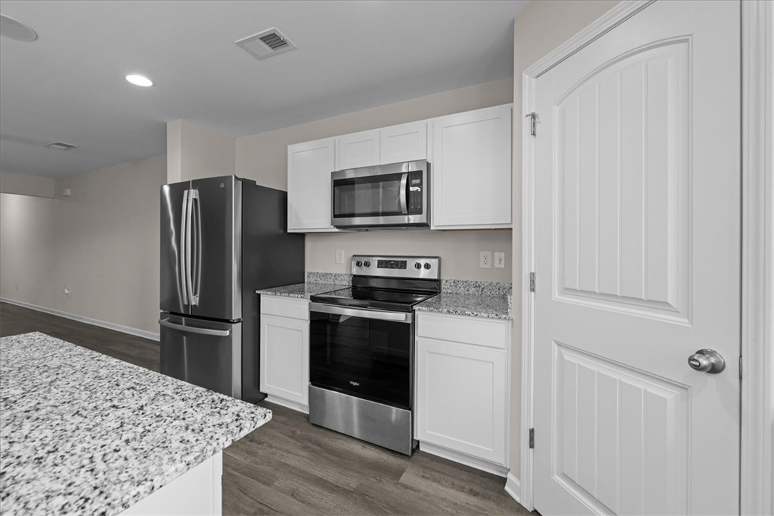 115 Adger Road Pendleton, SC 29670 - Photo 12 of 36 A well-appointed kitchen features stainless steel appliances, granite countertops, and light wood flooring.