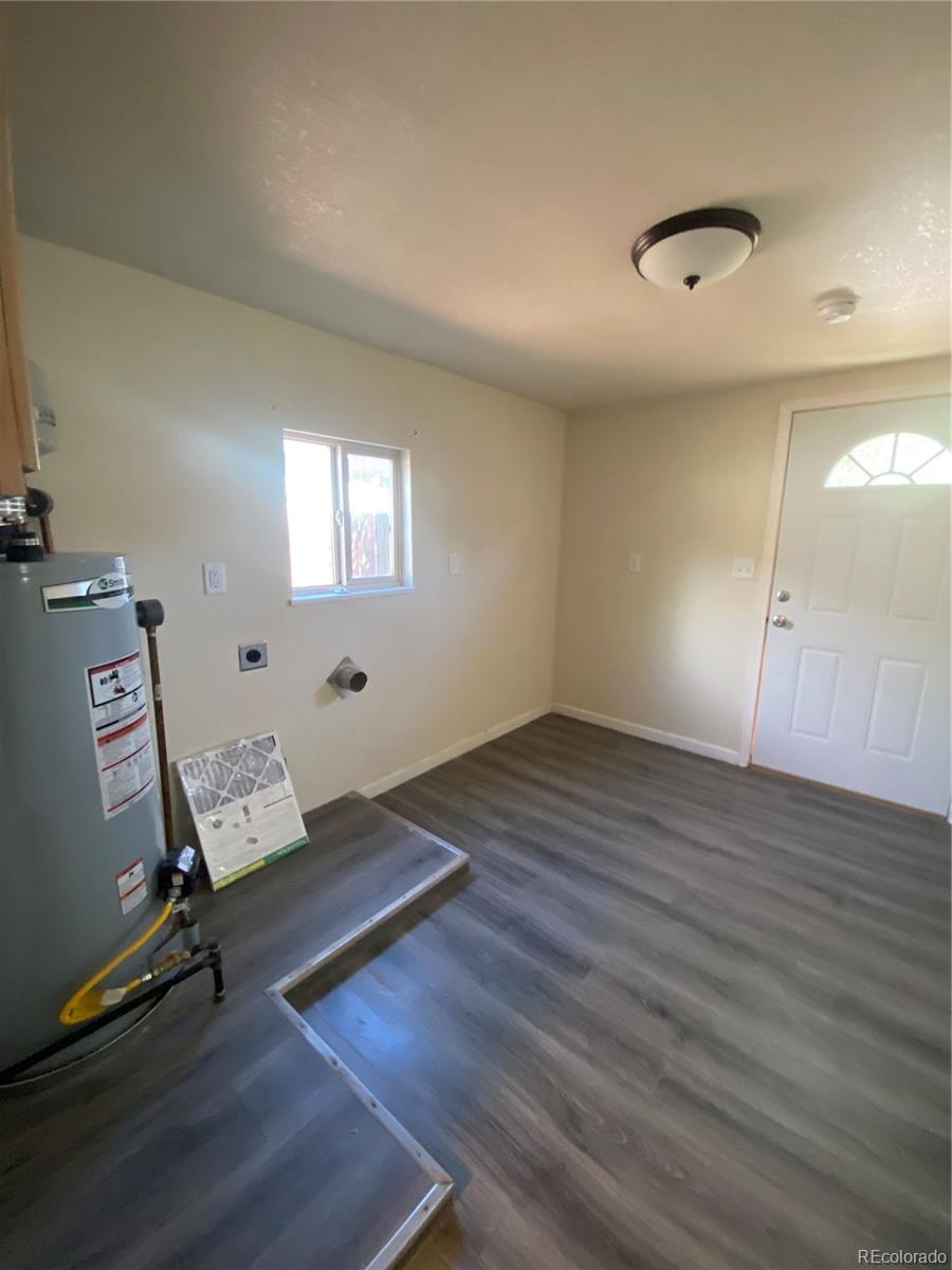 613 Lake Street Rangely, CO 81648 - Photo 12 of 12 an empty room with wooden floor and windows