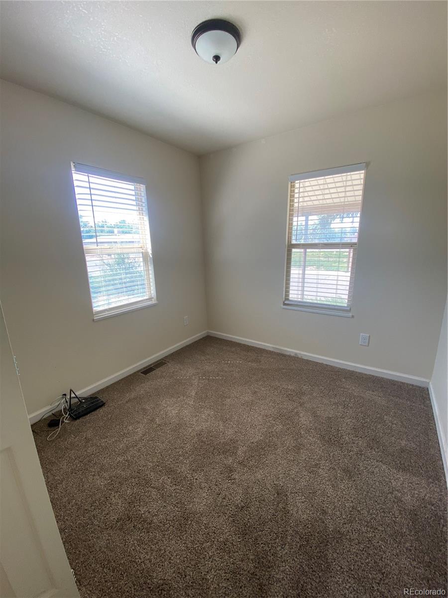 613 Lake Street Rangely, CO 81648 - Photo 7 of 12 an empty room with windows
