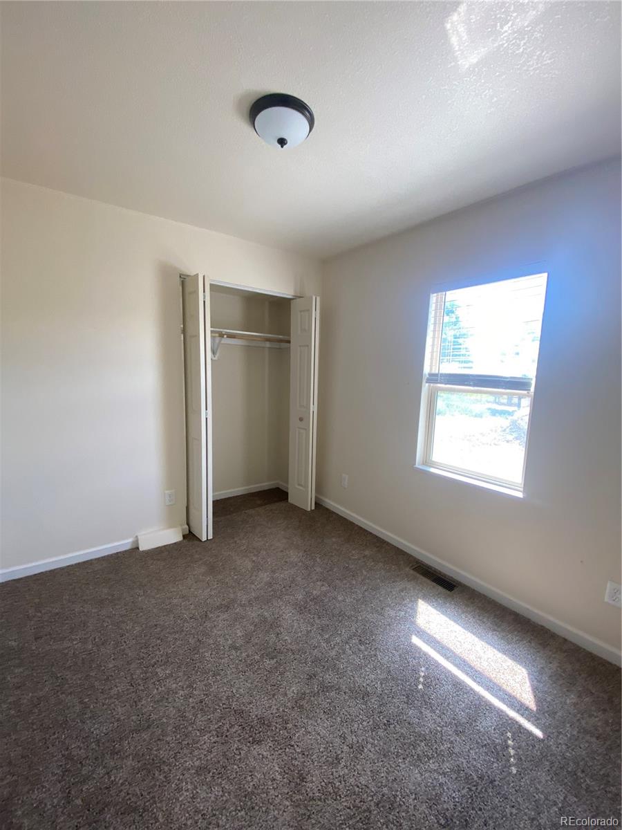 613 Lake Street Rangely, CO 81648 - Photo 8 of 12 an empty room with windows and closet