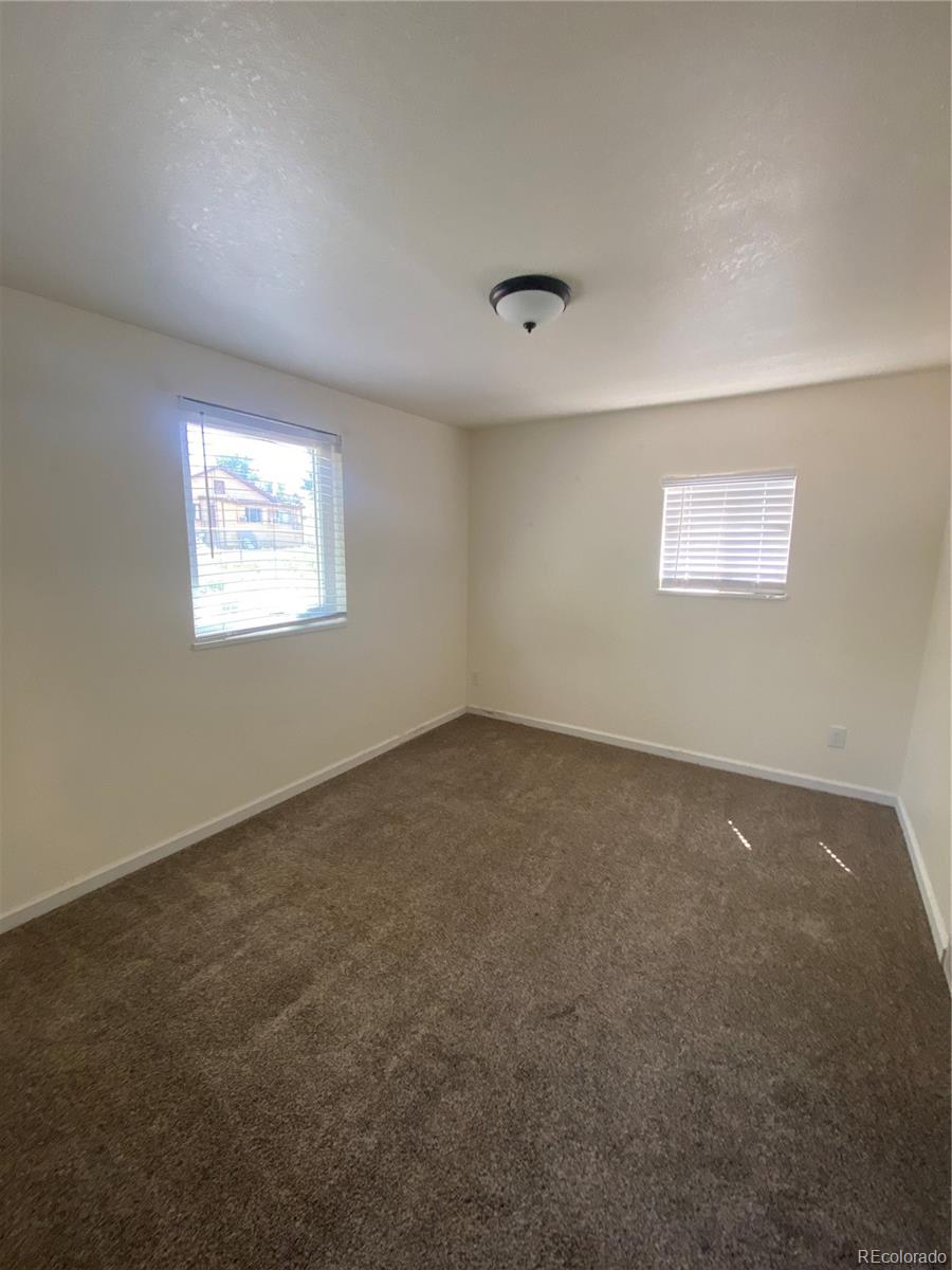 613 Lake Street Rangely, CO 81648 - Photo 9 of 12 an empty room with windows