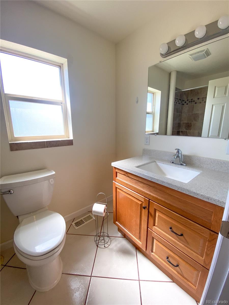 613 Lake Street Rangely, CO 81648 - Photo 10 of 12 a bathroom with a toilet sink and mirror
