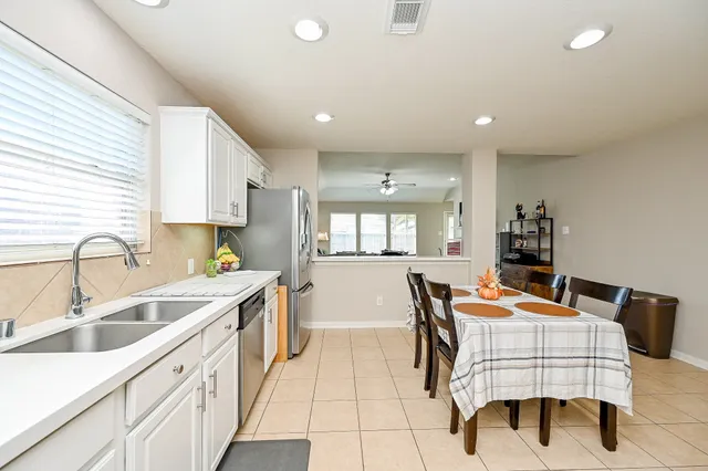 a kitchen with stainless steel appliances kitchen island granite countertop a sink and cabinets