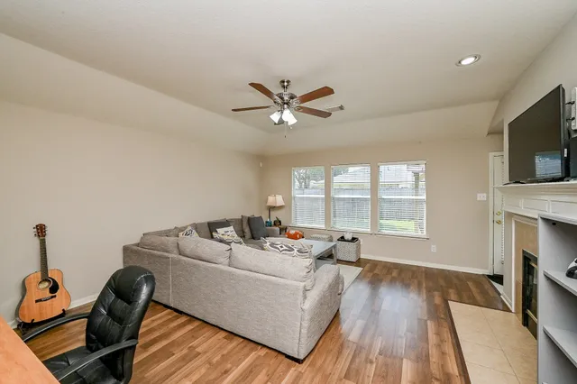 a living room with furniture fireplace and a flat screen tv