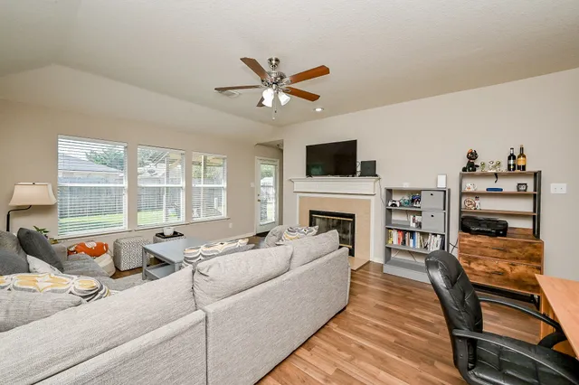 a living room with furniture fireplace and a flat screen tv