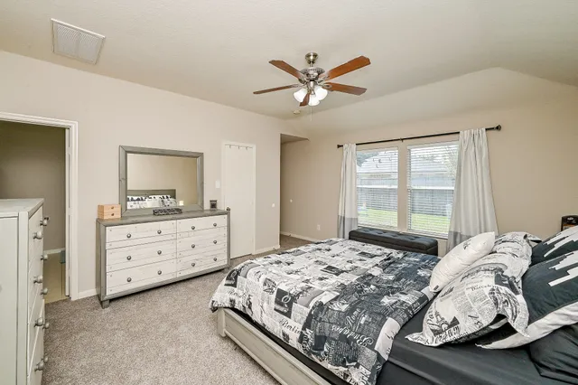 a bedroom with a bed and a window dresser