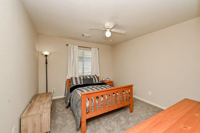 a bedroom with bed and window