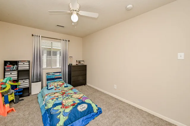 a bedroom with bed and a window