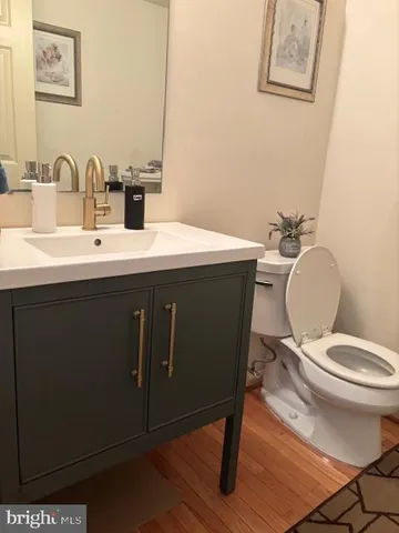 a bathroom with a toilet a sink and mirror