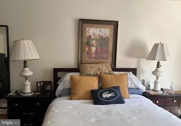 a bedroom with a bed and a lamp