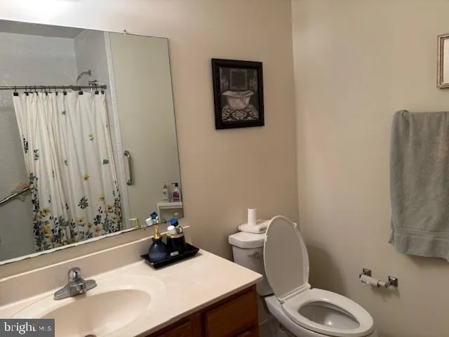 a bathroom with a sink mirror and toilet