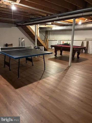 a room with wooden floor and furniture